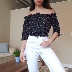 Off-shoulder black floral top with ruffles